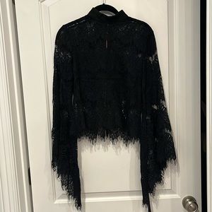 Black lace blouse with rose gold back zipper, bell sleeve, and raw lace hem